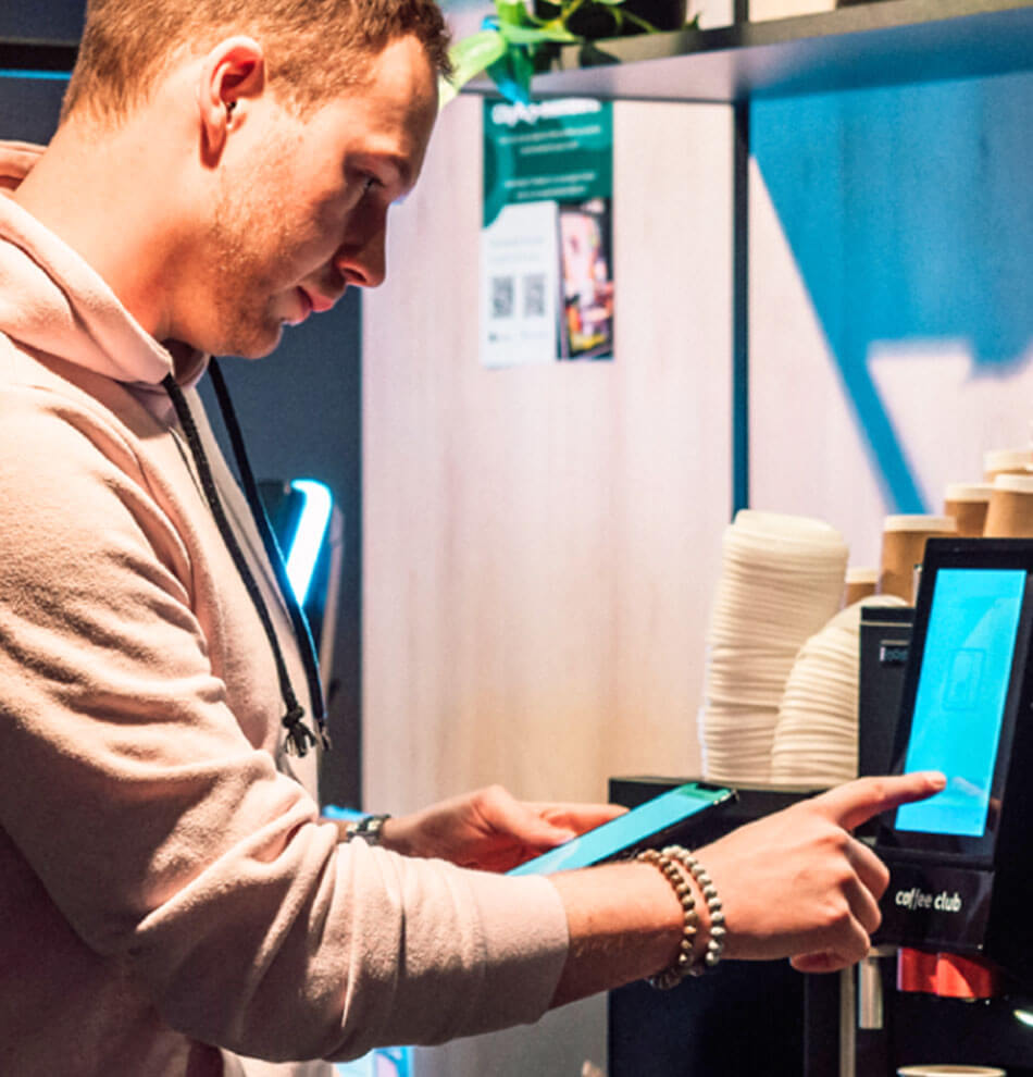 Man paying for food he has gotten from vending machine.